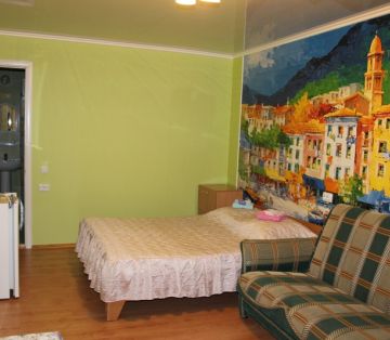 Холодильник, диван и кровать в номере Стандарт 3-4х местном отель Прибой Саки