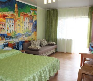 Двуспальная кровать, фотообои город, диван раскладной в номере Стандарт 3-4х местном отель Прибой Саки