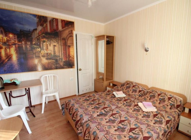 Две кровати, тумба, фотообои ночной город  в номере Стандарт 2х местный отель Прибой Саки